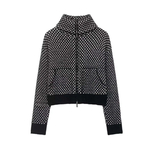 Detail view of checkerboard knit jacket with high collar and sturdy metal zipper