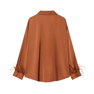 Caramel satin long-sleeved shirt featuring elegant feather cuffs and a smooth silk-like finish