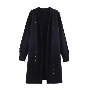 Women's black loose knit cardigan with white pearl bead embellishments on sleeves