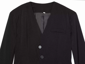 Detailed close-up of V-neck blazer romper with two-button closure and sleek black fabric