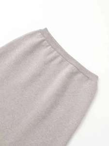 Detailed macro view showing the fine knit texture and ribbed high waistband of the skirt