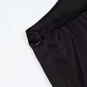 Close-up of black dress with invisible zipper and elastic waistband detail