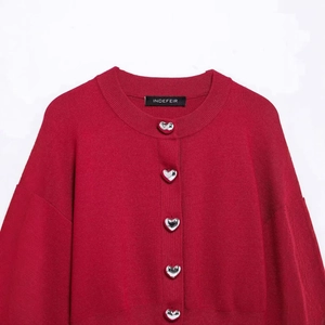 Red crewneck knit cardigan with silver heart buttons and drop shoulder style