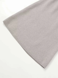 Detailed macro view of the grey knitted skirt showing fine fabric texture and hemline