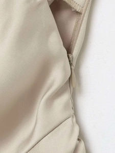 Macro detail of seamless invisible zipper and textured satin fabric on sleeveless top