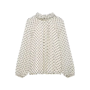 Detail of high neck vintage polka dot chiffon blouse with vertical pleated chest texture