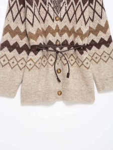 Close-up of vintage geometric wave knit texture and wooden buttons with brown leather belt