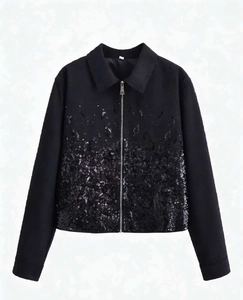 Close-up of black sequin gradient detail and silver zipper on the collar jacket