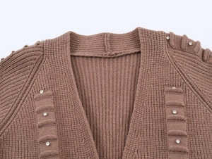 Detail of brown V-neck knit cardigan with rhinestone accents and ribbed texture