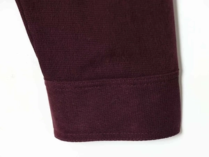 Close-up of premium burgundy fabric with high-density knit and double-needle stitching