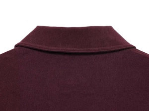 Detailed view of the dark red knit jacket collar and high-quality stitching texture