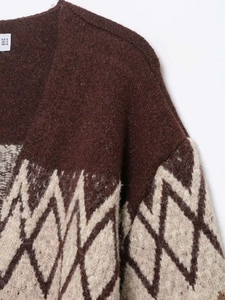 Detail of V-neck collar and argyle knit pattern on brown and beige cardigan