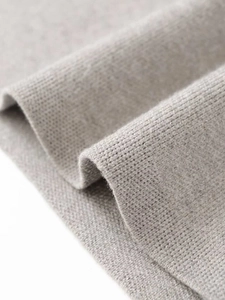 Macro shot of high-density soft light grey knitted fabric with fine wool texture