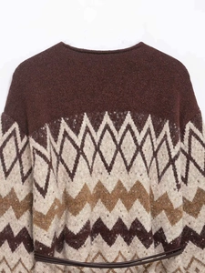 Detail of vintage V-neck knit sweater with jacquard patterns and a thin brown belt
