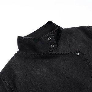Women's black asymmetrical denim jacket with diagonal metal buttons and stand collar