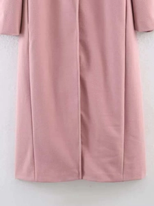 Detailed close-up showing the premium dusty pink wool texture of the long winter coat