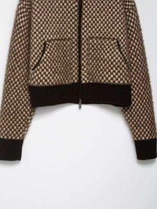 Detail of soft mohair knit texture and zipper pocket on brown checkered cardigan