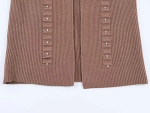 Close-up of brown ribbed knit cardigan with sparkling crystal rhinestone embellishments