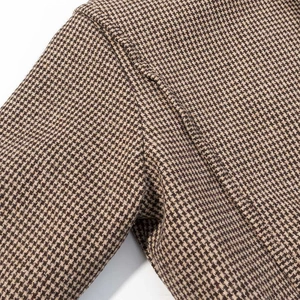 Detail of vintage houndstooth fabric with precise stitching on a retro flight jacket