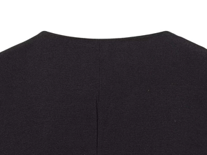 Macro shot of V-neck collar detail on a black long sleeve playsuit with fine woven texture