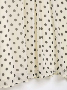 Detailed macro view of lightweight polka dot chiffon fabric with soft elegant drapes