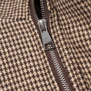Classic houndstooth plaid bomber jacket with a polished silver metal zipper detail