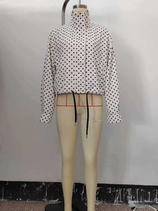 Detailed view of women's polka dot casual jacket with adjustable drawstring hemline