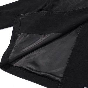 Detail view of the black denim jacket's smooth inner lining and neat hem stitching