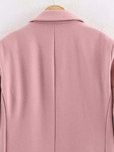 Detailed back view of a pink wool coat featuring professional tailoring and back seam detail
