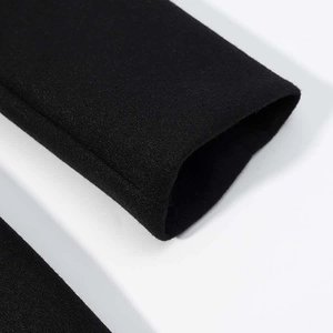 Close-up of cuff detail on black long commute coat featuring premium heavy fabric texture