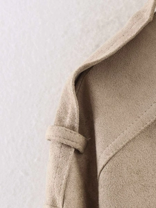 Close-up of beige suede jacket shoulder with epaulettes and detailed stitching