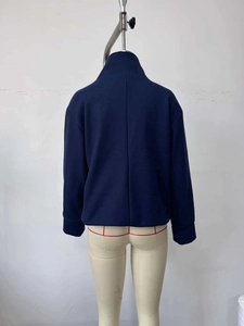 Rear view of navy blue wool jacket showing vertical back seam and drop shoulder detail