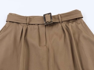 Detail of khaki midi skirt waist with matching belt and marble pattern buckle