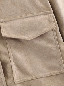 Detail shot of the suede-like fabric texture and flap pocket stitching on the khaki jacket