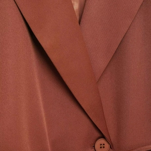 Terracotta notched lapel blazer featuring tailored waist and matte single button detail