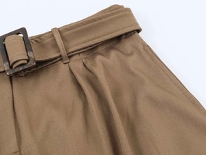 Detail of khaki midi skirt featuring twill fabric and belt with tortoiseshell buckle
