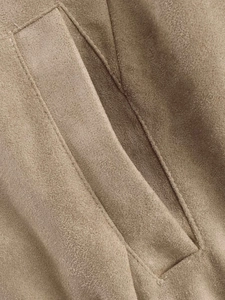 Macro detail of camel suede jacket featuring reinforced pocket seams and premium stitching