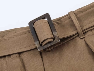 Detail of khaki midi skirt waist with matching fabric belt and tortoiseshell resin buckle