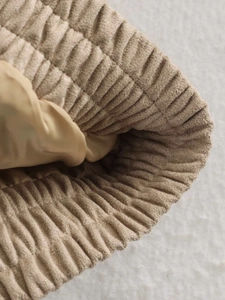 Detail of khaki corduroy jacket showing elastic pleated cuffs and smooth inner lining