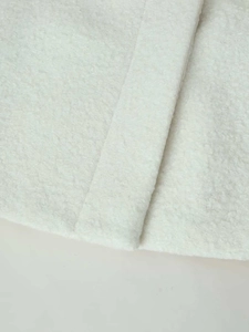 Macro shot of high-quality white sherpa fleece texture with thick soft fiber details