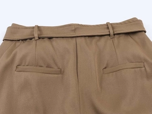 Detail showing back pockets and belt loops of khaki twill midi skirt waist design