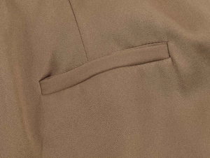Detailed view of the single welt pocket and twill texture on khaki midi skirt fabric