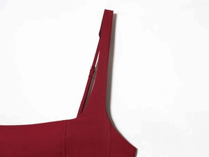 Detailed view of dark red satin dress with adjustable straps and fine stitching