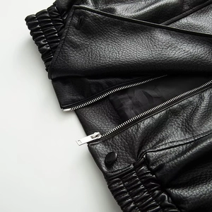 Women's black faux leather jacket with stand collar and detailed metal zipper and button