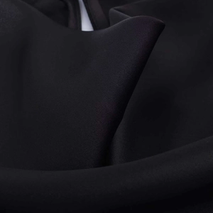 Vista macro dettagliata del tessuto satinato nero con trama densa e consistenza liscia