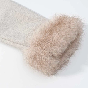 Close-up of grey wool fabric texture with luxurious light brown faux fur trim detail
