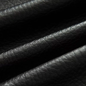 Macro shot showing high-quality black faux leather texture and lychee grain detail