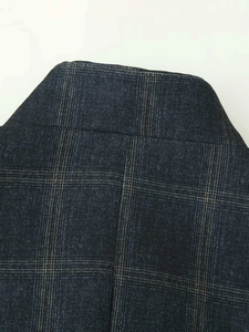 Macro shot of dark vintage plaid fabric texture with stand collar detail for women blazer