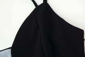 Close-up of thin black straps and textured chiffon fabric on a summer camisole dress