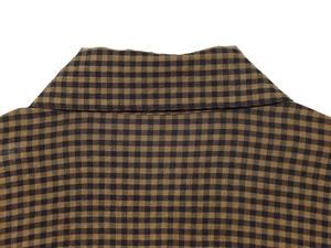 Detail view of small gingham fabric texture and stitching on the shirt collar